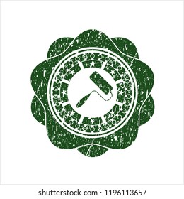 Green roller brush icon inside distressed rubber seal