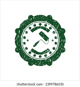 Green roller brush icon inside distressed rubber texture