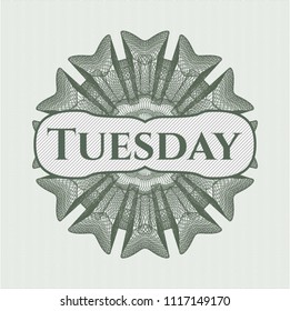 Green rosette (money style emblem) with text Tuesday inside
