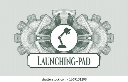 Green rosette or money style emblem with desk lamp icon and Launching-pad text inside