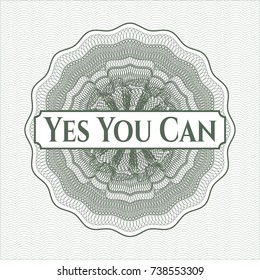 Green rosette (money style emblem) with text Yes You Can inside