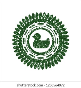 Green rubber duck icon inside distressed rubber grunge stamp