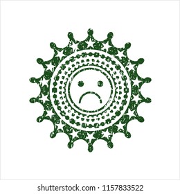 Green sad face icon inside distressed rubber grunge seal