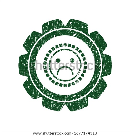 Green sad face icon inside distress rubber grunge seal