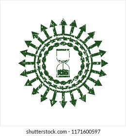 Green sand clock icon inside distressed grunge seal