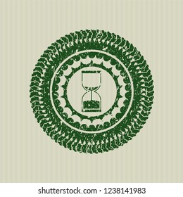 Green sand clock icon inside distress rubber seal