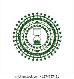 Green sand clock icon inside rubber texture