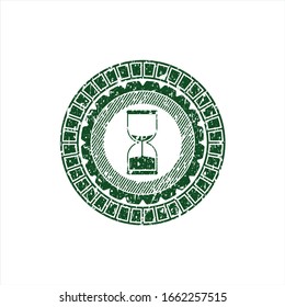 Green sand clock icon inside distressed rubber stamp with grunge texture
