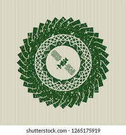 Green satelite icon inside rubber stamp with grunge texture