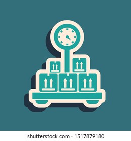 Green Scale with cardboard box icon isolated on blue background. Logistic and delivery. Weight of delivery package on a scale. Long shadow style. Vector Illustration