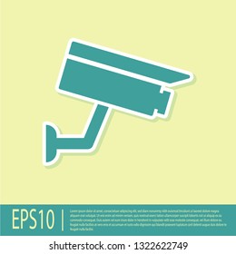 Green Security camera icon isolated on yellow background. Flat design. Vector Illustration