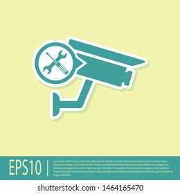 Green Security camera with screwdriver and wrench icon isolated on yellow background. Adjusting, service, setting, maintenance, repair, fixing.  Vector Illustration