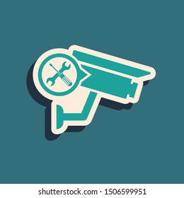 Green Security camera with screwdriver and wrench icon isolated on blue background. Adjusting, service, setting, maintenance, repair, fixing. Long shadow style. Vector Illustration