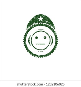 Green serious face icon inside distressed rubber seal