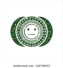 Green serious face icon inside distress with rubber seal texture