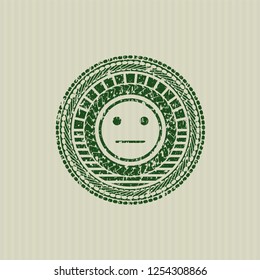 Green serious face icon inside rubber seal with grunge texture