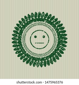 Green serious face icon inside rubber stamp with grunge texture