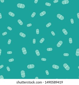 Green Sewing thread on spool icon isolated seamless pattern on green background. Yarn spool. Thread bobbin.  Vector Illustration