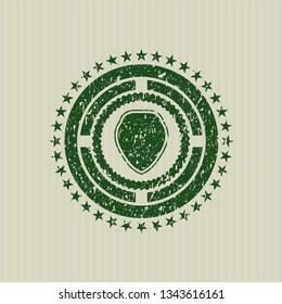 Green shield icon inside distress grunge stamp
