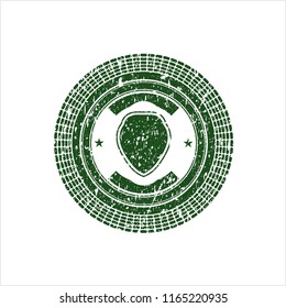 Green shield icon inside distressed rubber seal with grunge texture