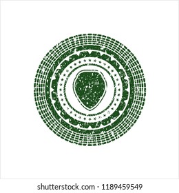Green shield icon inside rubber texture