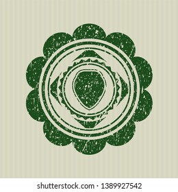 Green shield icon inside rubber grunge stamp