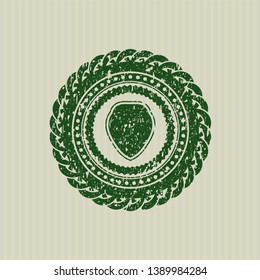 Green shield icon inside rubber grunge texture stamp
