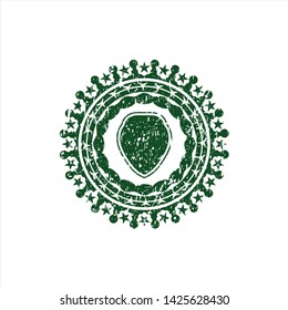 Green shield icon inside rubber texture