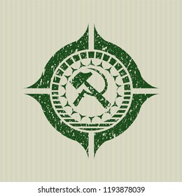 Green sickle and hammer icon inside rubber stamp with grunge texture