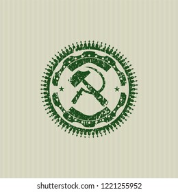 Green sickle and hammer icon inside distressed rubber grunge texture seal