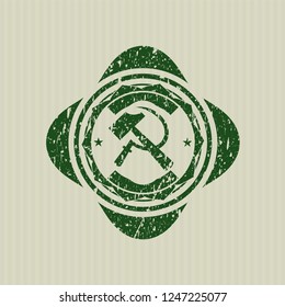 Green sickle and hammer icon inside distress with rubber seal texture