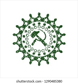Green sickle and hammer icon inside distress rubber seal with grunge texture