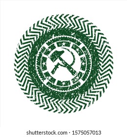 Green sickle and hammer icon inside grunge stamp