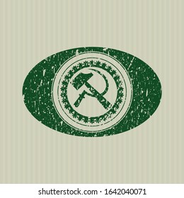 Green sickle and hammer icon with rubber seal texture