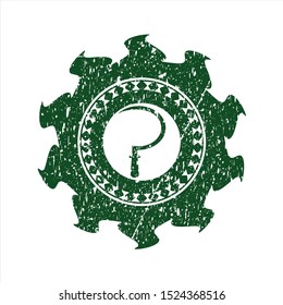 Green sickle icon inside distressed rubber stamp with grunge texture