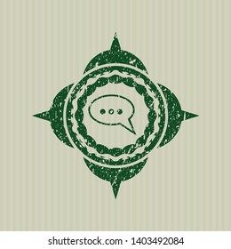 Green speech bubble icon inside distressed grunge stamp