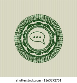 Green speech bubble icon with rubber seal texture