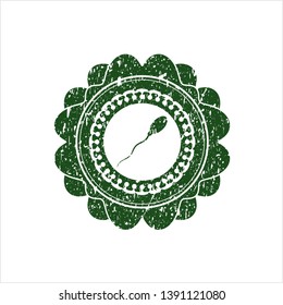 Green sperm icon inside distressed rubber seal