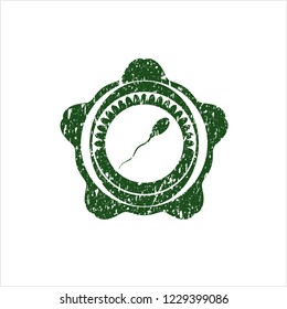 Green sperm icon inside rubber grunge texture seal