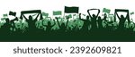 Green Sports background with soccer Football supporters in silhouette flat design. Male and female fans with hands in the air, banners, flags. Design with two layers.