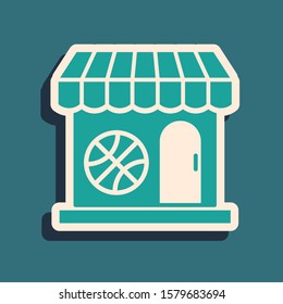 Green Sports shop and basketball ball icon isolated on blue background. Sport store. Long shadow style. Vector Illustration