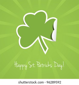 Green St Patricks Day background with rays and three-leaf clover.