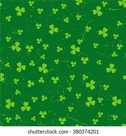Green St. Patrick's day pattern with clover leaves over grunge background.