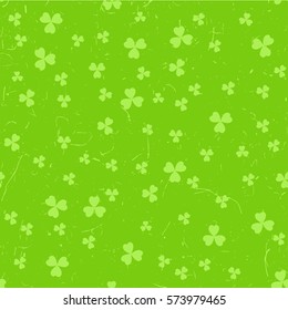 Green St. Patrick's day pattern with clover leaves over grunge background.