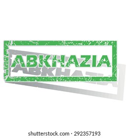 Green stamp with name Abkhazia and shadow, isolated on white