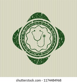 Green stethoscope icon inside rubber stamp with grunge texture