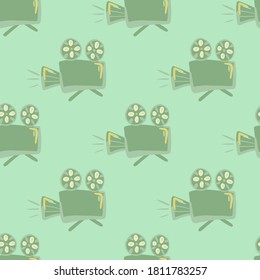 Green stylized cameras seamless pattern. Light turquoise background. Simple cinema style backdrop. Decorative backdrop for wallpaper, textile, wrapping paper, fabric print. Vector illustration.