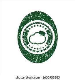 Green sun behind cloud icon inside rubber seal with grunge texture