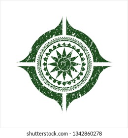 Green sun icon inside distressed rubber grunge seal