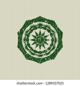 Green sun icon inside rubber stamp
